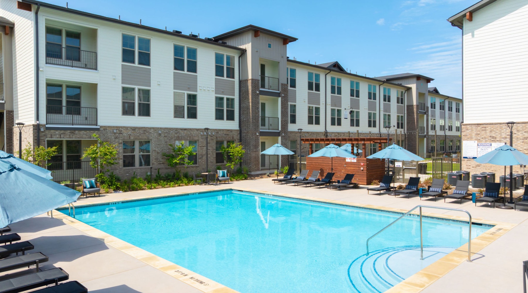 Resort-style swimming pool with lounge seating