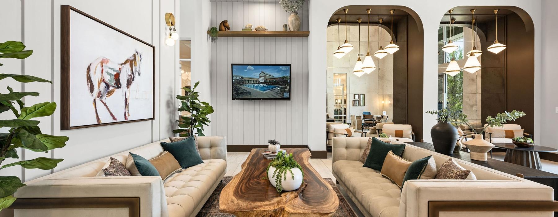 a spacious clubroom with ample light and sofas